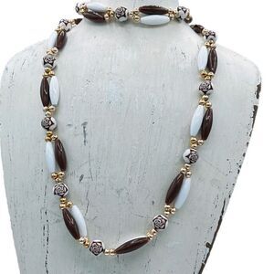 Vintage Germany 26” long brown and white necklace.